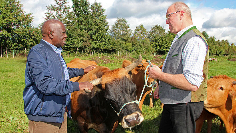 Zwei Öko-Produzenten, zwei Kontinente, eine gemeinsame Überzeugung: Bei seinem Besuch des Naturland-Betriebs von Milchbauer Georg Schlickenrieder bekam Stanley Maniragaba einen Eindruck von einem bayerischen Bio-Bauernhof – schnell waren sich beide Erzeuger einig: „Die Zukunft unserer Ernährung liegt in der Verbindung von Öko-Landbau und Fairem Handel.“ 