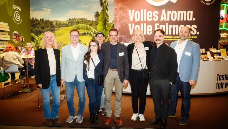 Gruppenfoto des GEPA-Teams mit sieben Personen vor dem Messestand.